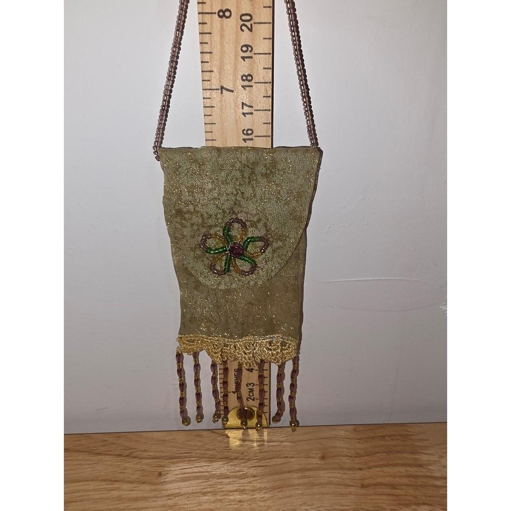 vintage-style beaded amulet pouch featuring a delicate embroidered floral design